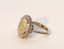 OPAL AND DIAMOND RING
14k white gold ring set with one opal weighing approx. 
5ct surrounded by brilliant-cut diamonds weighing approx. 1ct