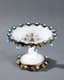 EUROPEAN OPAQUE GLASS VASE ON A STAND WITH DECORATION OF METALLIC GARLANDS OF LEAVES AND BLUE STONES