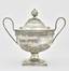 A silver sugar bowl with a lid and two fine handles decorated with floral ornament
