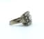 SQUARE DIAMOND RING
18k white gold and platinum ring with central diamond weighing 0,60ct surrounded by 12 diamonds weighing approx. 0,4ct