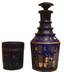 DECANTER WITH BUNG. GLASS WITH FLOWER ORNAMENT.