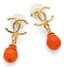 CHANEL 
Drop earrings with orange beads and a gold-tone CC logo, Fall 2023
