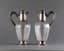 A PAIR OF FRENCH SILVER GILT AND CARVED GLASS DECANTERS ADORNED LIDS WITH PINECONE FINIAL