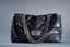 CHANEL
Black iridescent leather XXL shoulder travel bag with black metal hardwire