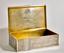 SILVER-GILT TROMPE L’OEIL CIGAR BOX, AFTER DESIGN OF TOBACCO COMPANY H. UPMANN WITH THE ENGRAVING «ТАБАКЪ ПРИВОЗНЫЙ» («IMPORTED TOBACCO»).
Konstantin Illarionovich Skvortsov’s workshop, Russia, Moscow, 1899-1908