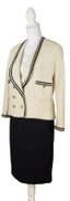 CHANEL
Cream bouclé jacket and black skirt suit