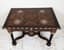 A RECTANGULAR ITALIAN MARQUETRY TABLE ON TWIST LEGS UNITED BY A FLATTENED “X” SHAPE STRETCHER