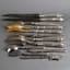 SET OF SILVER, HORN, AND METAL CUTELERY, 12 PIECES