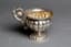 SILVER BOWL WITH GADROONED DECORATION AND HANDLE