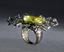 TSAVORITE RING
Silver ring set with a cushion light green stone surrounded by tsavorites