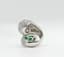DIAMOND AND EMERALD RING (WITH CERTIFICATE)
18k white gold bypass ring set with one cognac diamond and one emerald, with diamond surround