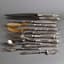SET OF SILVER, HORN, AND METAL CUTELERY, 12 PIECES