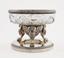 Silver-mounted cut crystal vase resting
on the three legs of winged lions on the base.