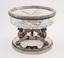 Silver-mounted cut crystal vase resting
on the three legs of winged lions on the base.