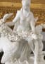 BISCUIT FIGURE ‘SITTING LEDA HOLDING A GARLAND OF FLOWERS WITH A SWAN AND A PUTTI’, 18TH-19TH CENTURY