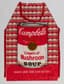ANDY WARHOL (1928-1987), AUTOGRAPH
Campbell’s Cream of Mushroom Soup Apron signed ‘Andy Warhol’ and dedicated 'to Jenny A.W.'