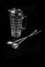 Cartier. Bar item with two spoons
Cut-crystal circled in silver. Spoons in silver