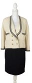 CHANEL
Cream bouclé jacket and black skirt suit